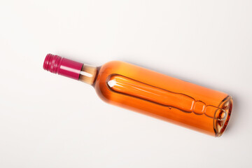 Sticker - Bottle of expensive rose wine on white background, top view