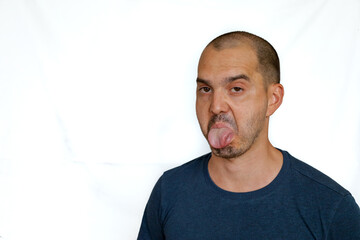 expressive bald man showing tongue