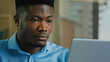 © Yuliia - African American business man employee professional manager working on laptop computer from home office male ethnic executive studying browsing web focused businessman analyzing digital data online