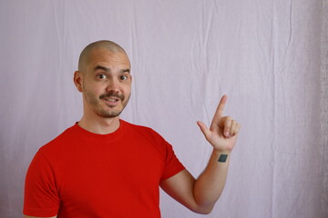 Sticker - casual bald man in red shirt making hand gestures , pointing something with fingers