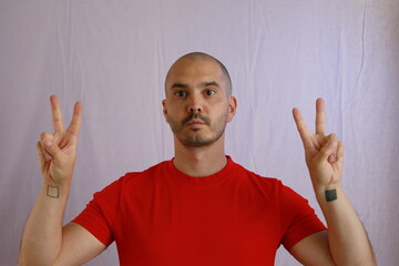 Sticker - casual bald man in red shirt making hand gestures , winner and victory