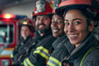 Group of interracial firefighters, women and men ready to get on fire truck
