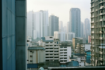 Wall Mural - Urban Serenity: Aerial View of Modern Asian Metropolis amidst Bangkok's Skyscrapers and Bustling Cityscape, with Towering Residential and Business Buildings lining the Streets, Against a Beautiful