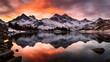 Panoramic view of snow covered mountains reflected in lake at sunset