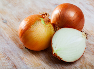 Wall Mural - Onion on wooden surface closeup. High quality photo