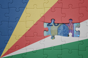 puzzle with the national flag of seychelles and euro banknote. finance concept