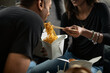 © Sean Locke/Stocksy - Loft: Woman Eating Lo Mein From Takeout Box