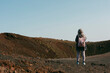 © Jimena Roquero/Stocksy - Woman on top of crater admiring views