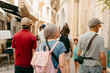 © Jimena Roquero/Stocksy - Group of tourist walking on an old Italian City.