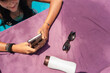 © Luis Herrera/Stocksy - woman at the pool with her phone