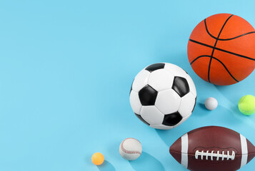 Canvas Print - Many different sports balls on light blue background, flat lay. Space for text