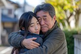 Fototapeta Londyn - asian teenage daughter hugging her father outside in town when spending time together