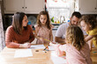 © Serena Burroughs/Stocksy - Happy family coloring togetehr at home