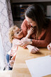 © Serena Burroughs/Stocksy - adorable girl hugging her mom at home indoors