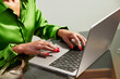 © ALTO IMAGES/Stocksy - Cropped image of businesswoman working on netbook at office