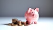 © Chayanin Wongpracha - A pink piggy bank sits beside a stack of pennies