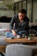 © MEM Studio/Stocksy - A man reading a book in a cafe