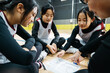 © ZQZ Studio/Stocksy - Teenager girls in basketball uniform looking at the strategy on floor