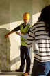© Oleksii Syrotkin/Stocksy - Architect Discuss Wall Measurements Client Construction Site
