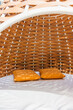 © Heng Yu/Stocksy - Comfortable woven rattan chair under sunlight.