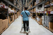 © Hernandez & Sorokina/Stocksy - Client Walking With Shopping Cart At Warehouse