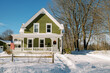 © Serena Burroughs/Stocksy - Green house in new england after snow storm in winter