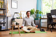 © ALTO IMAGES/Stocksy - Self-employed man meditating on mat after workday