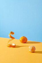 Peel Of An Orange Isolated At Yellow Table On Blue Background