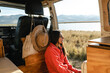© Luis Herrera/Stocksy - woman enjoying nature traveling in camper van