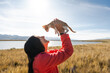 © Luis Herrera/Stocksy - Happy Woman and Kitten bonding and Enjoying a Carefree Day outdoors