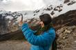 © Luis Herrera/Stocksy - travel woman taking photo with cell phone