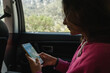 © Luis Herrera/Stocksy - woman traveler in car using phone map