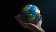 © David Angkawijaya - hands holding a earth on a dark background