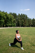 © Hernandez & Sorokina/Stocksy - Woman Performing Stretching Exercise In The Park