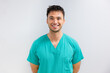 © VICTOR TORRES/Stocksy - Portrait of cheerful young male surgeon in scrubs