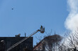 © Alvaro Lavin/Stocksy - Firefighter on a high crane.