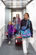 © Anya Brewley Schultheiss/Stocksy - Group of children walking the ramp that boards an airplane