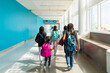© Anya Brewley Schultheiss/Stocksy - Group of children walking down a airport hall with their luggage.