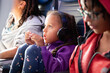 © Anya Brewley Schultheiss/Stocksy - Closeup portrait of a child watching an inflight movie.