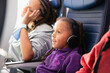 © Anya Brewley Schultheiss/Stocksy - Closeup portrait of a child watching an inflight movie.