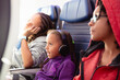 © Anya Brewley Schultheiss/Stocksy - Portrait of a child with headphones watching an inflight movie