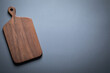 Wooden chopping board. Walnut handmade wooden cutting board on tabletop. Wood cutting board background. 