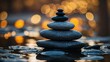 zen stones on the beach, calm stack of smooth river stones against a backdrop of golden bokeh lights reflecting water