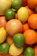 © New Africa - Different fresh citrus fruits as background, top view