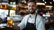 Happy waiter serving beer drinks while working in bar