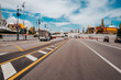 © Helen Rushbrook/Stocksy - A wide road in Bangkok with traffic and temple roofs