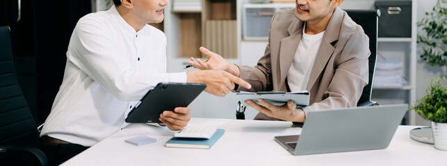 Wall Mural - Business people making presentation with his colleagues and business smartphone, tablet digital computer as meeting concept