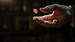 © Ali - person's hand tossing a coin