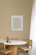© Artem Podrez/Stocksy - Frame with an empty space against a modern dining room