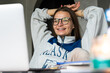 © Ivan Haidutski/Stocksy - Young happy woman working online remotely at home